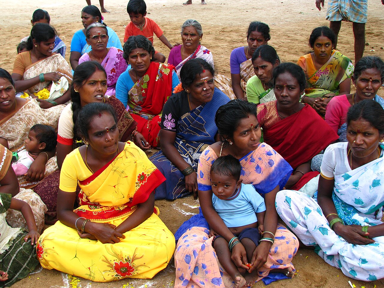 Women in a village collective discussing their savings plan